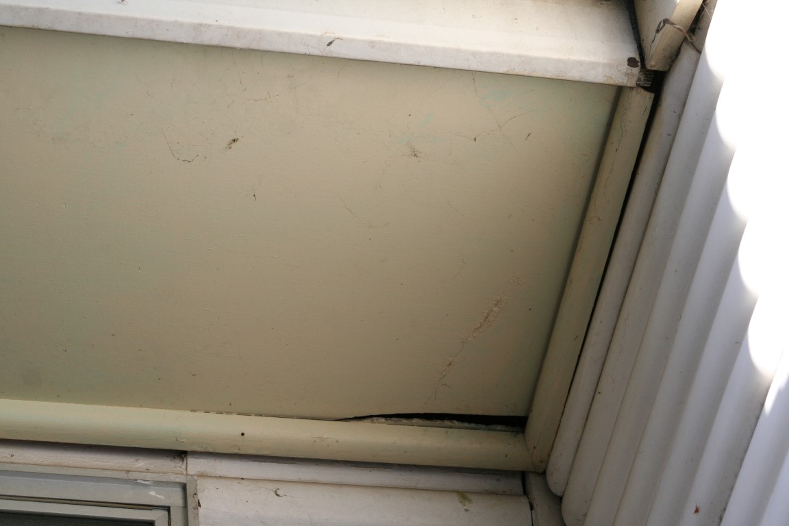 Asbestos eave and corrugated cladding