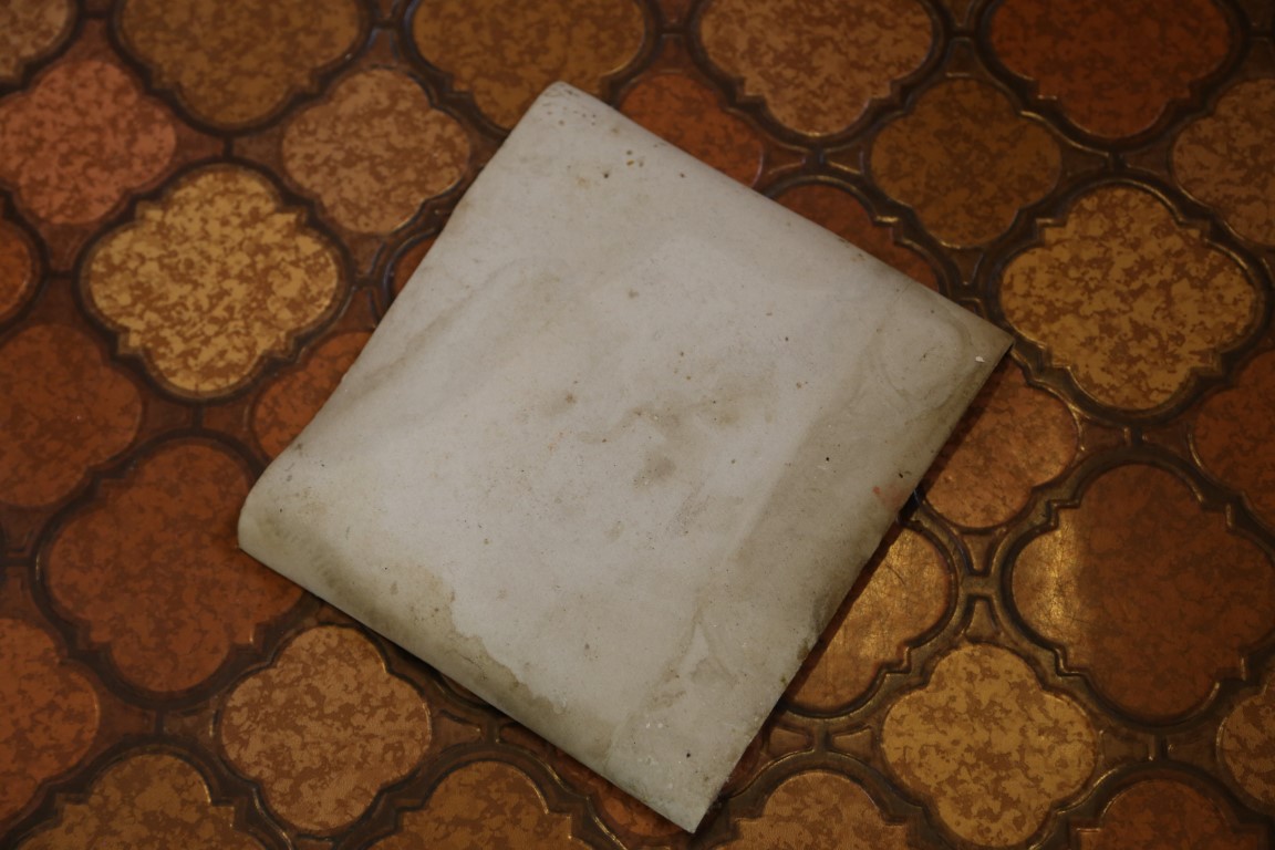 Vinyl floor covering in a kitchen and laundry showing the asbestos-containing backing