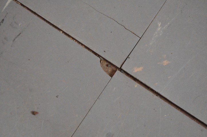 Lino floor tiles that are lifting