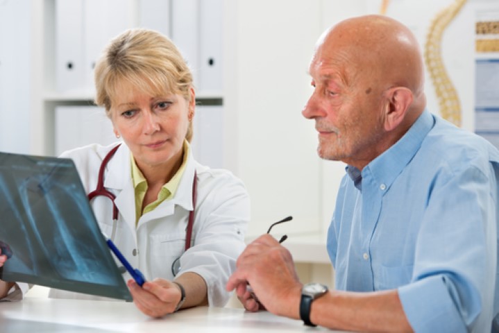 Doctor and a male patient reviewing an x ray