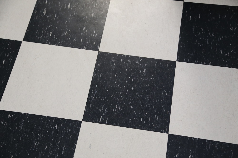 Large black and white checker lino floor tiles used in kitchens.  