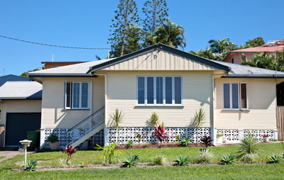 Australian weatherboard house with triple front and stairs on the left