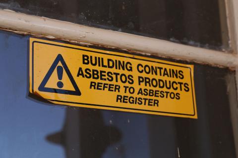 Sign that says 'building contains asbestos products'