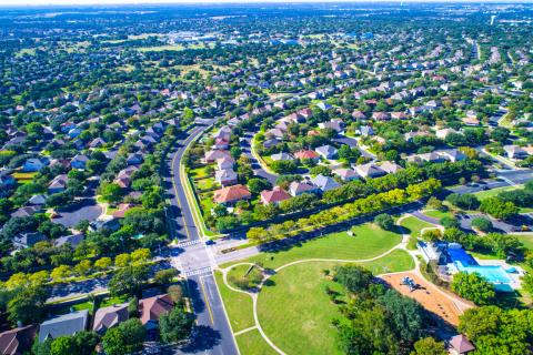 Aerial view of housing estate showing roads and roofs